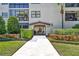 Andalucia condominium building entrance with lush landscaping and well-maintained walkway at 535 N Interlachen Ave # 107, Winter Park, FL 32789