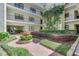 Beautiful courtyard featuring lush landscaping, a decorative fountain, and access to the building's amenities at 535 N Interlachen Ave # 107, Winter Park, FL 32789