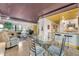 Dining space with a glass table next to the kitchen and living area at 535 N Interlachen Ave # 107, Winter Park, FL 32789