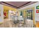 Inviting dining area adjacent to the kitchen, featuring a glass table and natural light at 535 N Interlachen Ave # 107, Winter Park, FL 32789