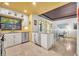 Bright eat-in kitchen with stainless steel appliances, white cabinets, and a window overlooking foliage at 535 N Interlachen Ave # 107, Winter Park, FL 32789