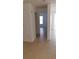 Hallway featuring neutral tile floors and an open layout to other rooms at 5479 Vineland Rd # 9104, Orlando, FL 32811