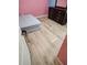 Bedroom featuring light wood flooring, a mattress, and a dark wood dresser at 625 Silverthorn Pl, Groveland, FL 34736