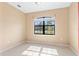 Bedroom featuring neutral paint, tile floors, large window and natural light at 625 Silverthorn Pl, Groveland, FL 34736