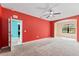 Spacious bedroom with carpet, ceiling fan, and access to other rooms at 625 Silverthorn Pl, Groveland, FL 34736