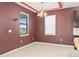 An empty dining room with red accent walls, tile floor, and large window letting in natural light at 625 Silverthorn Pl, Groveland, FL 34736