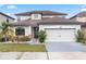 Charming two-story home with a manicured lawn, attached two-car garage, and beautiful landscaping at 625 Silverthorn Pl, Groveland, FL 34736