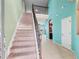 Bright foyer features tile flooring, staircase with carpet and iron railing, open concept, and ample natural light at 625 Silverthorn Pl, Groveland, FL 34736