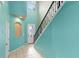Bright foyer with tile flooring, tall ceilings, staircase with iron railing, and ample natural light at 625 Silverthorn Pl, Groveland, FL 34736