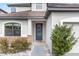 Charming home exterior featuring a blue front door, stone accents, and manicured landscaping at 625 Silverthorn Pl, Groveland, FL 34736