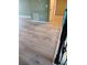 Hallway with hardwood flooring leading to a door at 625 Silverthorn Pl, Groveland, FL 34736