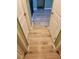 Hallway view showcasing the light wood flooring and white trim around the door frames at 625 Silverthorn Pl, Groveland, FL 34736