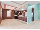 Open-concept kitchen featuring stainless steel appliances, granite countertops, tile floors, and an island with a sink at 625 Silverthorn Pl, Groveland, FL 34736