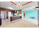 Spacious kitchen with dark cabinets, an island with granite countertops and stainless steel appliances at 625 Silverthorn Pl, Groveland, FL 34736