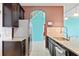 A kitchen with brown cabinets, granite countertops, stainless steel appliances and a view to the blue walled room at 625 Silverthorn Pl, Groveland, FL 34736