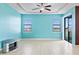 Bright living room with tile flooring, ceiling fan, large windows, and slider doors with ample natural light at 625 Silverthorn Pl, Groveland, FL 34736