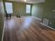 Spacious living room features hardwood flooring, two windows, and natural light at 625 Silverthorn Pl, Groveland, FL 34736