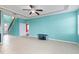 Spacious living room with tile flooring, large windows, and a ceiling fan, perfect for entertaining at 625 Silverthorn Pl, Groveland, FL 34736