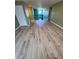 Second story view with hardwood flooring, stairway with iron railings, and natural light at 625 Silverthorn Pl, Groveland, FL 34736
