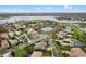 Stunning aerial view of a well-maintained home, featuring lush landscaping and a picturesque lakeside community at 7135 Ticklegrass St, Winter Garden, FL 34787