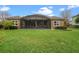 The backyard offers a screened-in lanai and beautifully manicured lawn, perfect for outdoor relaxation and entertaining at 7135 Ticklegrass St, Winter Garden, FL 34787