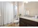 Bright bathroom with a shower-tub combo and vanity with granite countertop at 7135 Ticklegrass St, Winter Garden, FL 34787