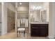 Bright bathroom featuring tiled shower, dark wood vanity and large mirror provides a relaxing spa-like feel at 7135 Ticklegrass St, Winter Garden, FL 34787