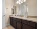 Bathroom featuring double vanity with granite countertops and modern fixtures at 7135 Ticklegrass St, Winter Garden, FL 34787
