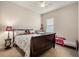 Bedroom with carpet flooring, a ceiling fan and a window bringing in natural light at 7135 Ticklegrass St, Winter Garden, FL 34787
