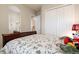 Cozy bedroom with floral bedding and a view leading to an ensuite bathroom and a closet at 7135 Ticklegrass St, Winter Garden, FL 34787