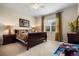 Cozy carpeted bedroom with a window providing natural light at 7135 Ticklegrass St, Winter Garden, FL 34787