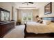 Spacious bedroom with a dresser, large windows, and neutral carpeting offers style and comfort at 7135 Ticklegrass St, Winter Garden, FL 34787