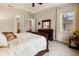 Bedroom features a dresser with mirror, a window with bright natural light, and ensuite bathroom entrance at 7135 Ticklegrass St, Winter Garden, FL 34787