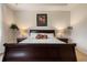 Symmetrical bedroom with decorative lamps and matching nightstands flanking a plush bed and headboard at 7135 Ticklegrass St, Winter Garden, FL 34787