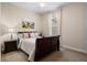 Comfortable bedroom featuring a full-sized bed, painting and bright window at 7135 Ticklegrass St, Winter Garden, FL 34787