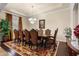 Formal dining room with a decorative rug, elegant chandelier, and seating for eight at 7135 Ticklegrass St, Winter Garden, FL 34787