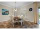 Cozy dining room with a round table, six chairs, pendant lighting, and tile flooring at 7135 Ticklegrass St, Winter Garden, FL 34787