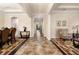 Elegant foyer showcasing tile floors, decorative rugs, and an arched entrance leading to the living area at 7135 Ticklegrass St, Winter Garden, FL 34787