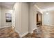Inviting hallway featuring tile flooring and neutral paint, leading to various rooms in the home at 7135 Ticklegrass St, Winter Garden, FL 34787
