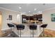 Spacious kitchen with a large island, dark cabinets, stainless appliances, and barstool seating at 7135 Ticklegrass St, Winter Garden, FL 34787