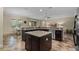 Modern kitchen with stainless steel appliances, granite countertops, and an island at 7135 Ticklegrass St, Winter Garden, FL 34787