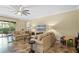 Bright living room with tile floors, a ceiling fan, and access to the patio at 7135 Ticklegrass St, Winter Garden, FL 34787