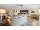 Open-concept living area with tile flooring, a view of the kitchen, and comfortable seating at 7135 Ticklegrass St, Winter Garden, FL 34787