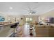 Open living room with bar seating, tile floors, lots of light, and access to the backyard at 7135 Ticklegrass St, Winter Garden, FL 34787