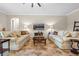 Cozy living room featuring two sofas, tile floors, and a decorative coffee table at 7135 Ticklegrass St, Winter Garden, FL 34787