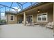 Covered patio with a variety of seating and ample space for entertaining at 7135 Ticklegrass St, Winter Garden, FL 34787
