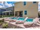 Inviting backyard area with pool, spa, lounge chairs, patio, and outdoor dining for ultimate relaxation at 7568 Marker Ave, Kissimmee, FL 34747