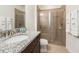Modern bathroom featuring glass shower, granite sink and clean design elements at 7568 Marker Ave, Kissimmee, FL 34747