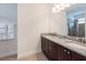 Elegant bathroom featuring a double vanity, granite countertops, and a glass-enclosed shower at 7568 Marker Ave, Kissimmee, FL 34747