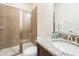 Bathroom featuring glass door shower, a granite sink, and modern fixtures at 7568 Marker Ave, Kissimmee, FL 34747